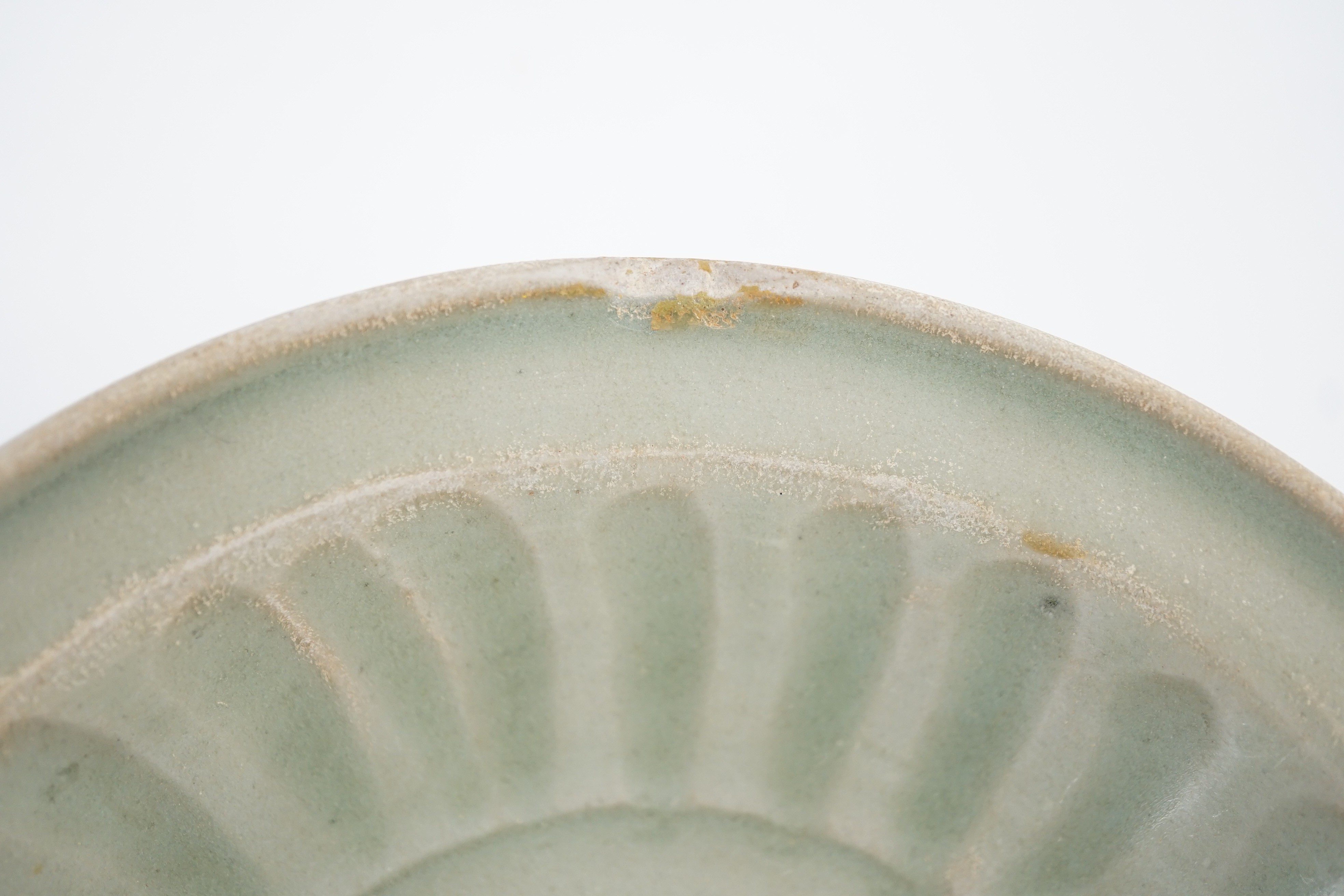A small Chinese Ming Longquan celadon dish, 15th/16th century, 16.2cm diameter, some faults